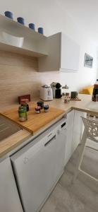 勒格罗-迪鲁瓦Terrasse 4 quai du port de plaisance的配有白色橱柜和木质台面的厨房 更多36张照片