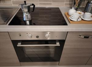 a kitchen with a coffee maker on top of a stove at Casa Samu in Cornaredo +2 photos