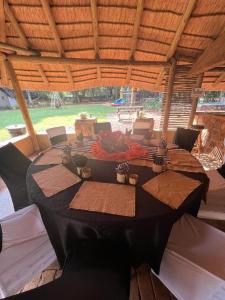 a large table in a pavilion with a tableablish at Harties Is Africa Safari Lodge in Hartbeespoort
