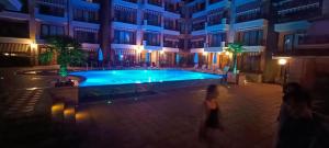 a swimming pool in the middle of a building at night at Boulevard Sea Residenz 250 meter zum Sandstrand in Sunny Beach