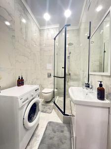 a white bathroom with a washing machine and a sink at Новая Евродвушка на Левом берегу Астаны, Экспо, МегаСилквэй in Astana