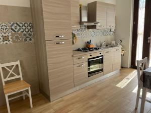 a kitchen with a stove top oven in a room at Is Bangius in Bacu Abis
