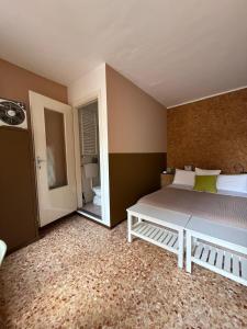 a bedroom with a large bed and a mirror at Antico Affittacamere di Tollegno in Tollegno