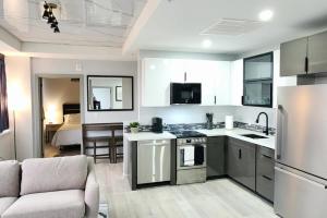 a kitchen with white appliances and a living room at Modern High-Rise Apartment - 4 in Tulsa