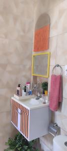 a bathroom with a sink and a mirror at Espaço Sol e Mar in Salvador