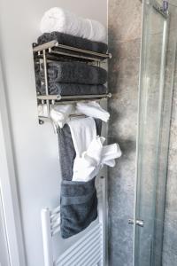 a towel rack with towels in a bathroom at 4 Guests - 2 Bedrooms - City Escape Retreat in Stoke on Trent