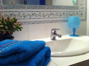 a bathroom with a sink and a blue towel at Le tilleul du parc de la dame in Latour-Bas-Elne +9 photos