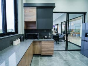 a kitchen with a counter with a microwave and a refrigerator at Humdani Safaris Free State in Virginia