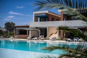 a house with a swimming pool in front of it at Domaine Darsyada Boutique Hôtel Deluxe Et Spa in Marrakesh
