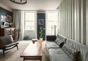 a living room with a couch and a coffee table at Shipmaster's Townhouse in Queensferry