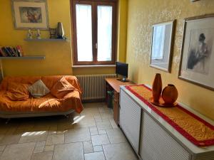 a living room with a couch and a desk with a computer at Rosemary 2 in Fano +24 photos