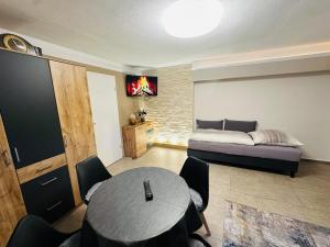 een woonkamer met een bed, een tafel en stoelen bij FeWo Zimmervermietung Bornemann  +13 foto's
