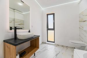 a bathroom with a sink and a toilet at KOA - Street in Braşov +33 photos