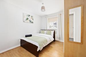 a bedroom with a bed and a mirror on the wall at North Dublin Oasis in Dublin