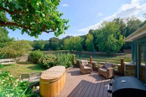 a wooden deck with a table and chairs on it at The Boathouse - Salcombe - Spring Time Tiny Home in Salcombe +13 photos
