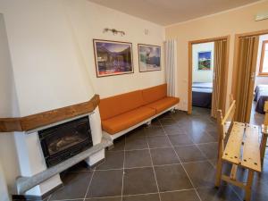 a living room with a couch and a fireplace at Apartment in Antey-Saint-André near Ski Lift in Antey-Saint-André