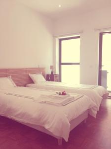 two beds sitting next to each other in a bedroom at Casa dos Pátios II in Aveiro