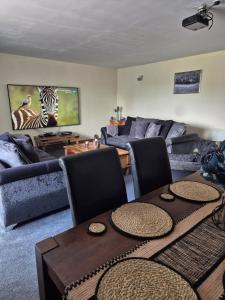 a living room with a couch and a table at The Yard Bungalow in Sanquhar