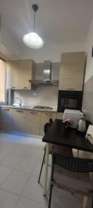 a kitchen with a table and a kitchen with a stove at Alessandro's Home in Rome