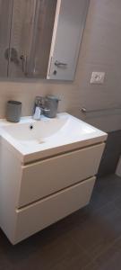 a bathroom with a white sink and a mirror at Alessandro's Home in Rome +13 photos