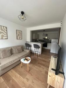 a living room with a couch and a table at Playa Del Sol Moderne Clim Vélo in Sainte-Marie-la-Mer