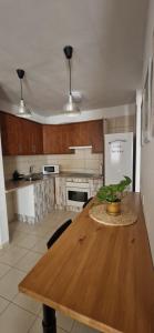 a kitchen with a wooden table and a refrigerator at Las Brisas in Granadilla de Abona