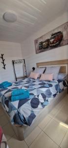 a bedroom with a bed with blue and pink pillows at Las Brisas in Granadilla de Abona