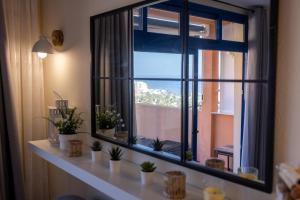 a window in a room with plants on a shelf at Casa Guillaume in Mogán +69 photos