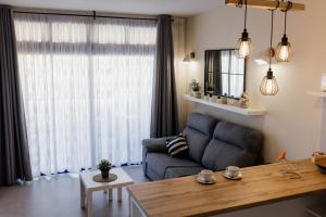 a living room with a couch and a large window at Casa Guillaume in Mogán