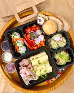 a tray with three trays of food on a table at Glamp Mała Łąka Jacuzzi & Sauna Zakopane in Zakopane