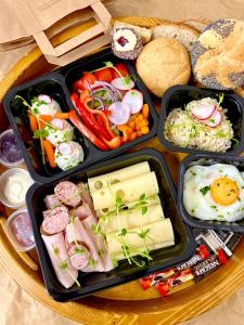 a tray with three trays of food on a table at Glamp Mała Łąka Jacuzzi & Sauna Zakopane in Zakopane +82 photos