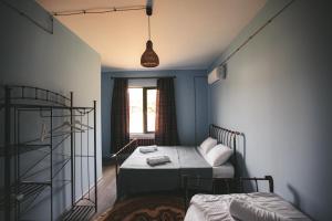 a bedroom with two beds and a window at Ethno Village in Shilda