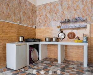 a kitchen with a table with pots and pans at Villages Đường Thùy Vân Bãi Sau Gần Biển in Vung Tau