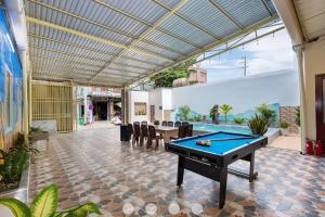 an outdoor entertaining area with a pool table and a patio at Villages Đường Thùy Vân Bãi Sau Gần Biển in Vung Tau