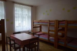 a dining room with two bunk beds and a table at Chata Nová Seninka in Staré Město