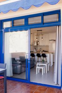 a living room and kitchen with a large sliding glass door at Casa Guillaume in Mogán