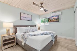 a bedroom with a bed and a ceiling fan at Sea Dream - Pet Friendly, Located in Siesta Key Village, Steps to Siesta Key Beach! in Bailey Hall