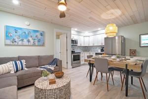 a living room and kitchen with a couch and a table at Sea Dream - Pet Friendly, Located in Siesta Key Village, Steps to Siesta Key Beach! in Bailey Hall