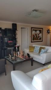 a living room with a couch and a coffee table at Chipipe Riviera del Mar in Salinas