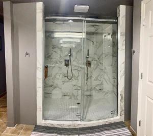 a bathroom with a shower with marble walls at Washington Loft in Saint Louis +30 photos