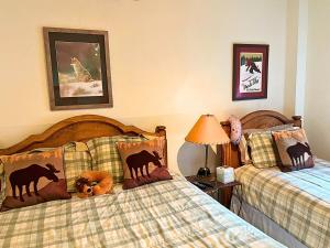 a bedroom with two beds with animals on them at Park Station 3 min walk to Town Lift and Main St in Park City
