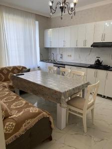 a kitchen with a large stone table and chairs at Green Villa in Vǝndam