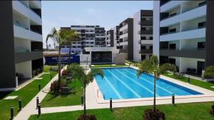 an image of an apartment complex with a swimming pool at Marina Cerritos Mazatlan in La Florida