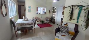 a living room with a table and chairs and a room with a table at Espaço Sol e Mar in Salvador