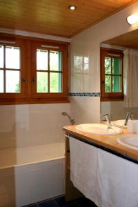 a bathroom with two sinks and a bath tub at Chalet Marie Paradis in Saint-Gervais-les-Bains