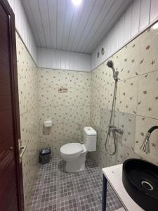 a bathroom with a shower and a toilet and a sink at Istana Bromo Resort in Bromo +78 photos