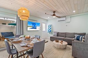 a living room with a table and a couch at Sea Escape - Pet Friendly, Located in Siesta Key Village, Steps to Siesta Key Beach! in Bailey Hall