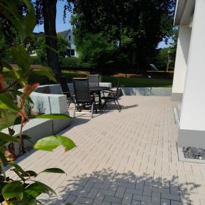 un patio con sillas y mesas en Ferienwohnung Jost, en Allendorf
