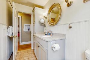 a bathroom with a sink and a mirror on the wall at 10-Minute Walk to the Beach  +15 photos