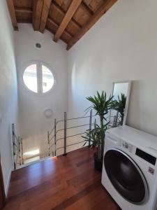 a laundry room with a washing machine and a window at Residenza Elena227 in Vicenza